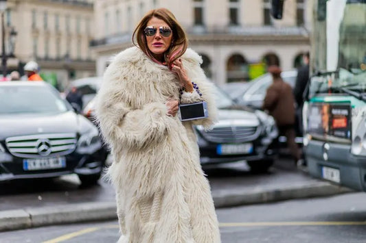 Stylish women wearing eco-friendly faux fur coats in winter